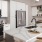 Spacious and well lit kitchen with wood flooring and stainless steel appliances