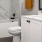 Large well lit bathroom with white accents 