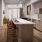 Model kitchen at our apartments in Plano, TX, featuring a kitchen island and stainless steel appliances.